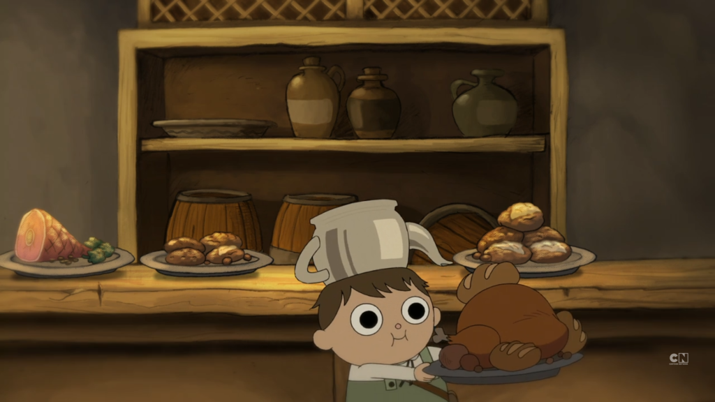 Greg feasts on turkey and bread while wearing a cauldron (kettle) on his head